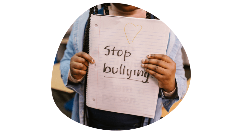 Un enfant brandit une pancarte « Stop bullying »